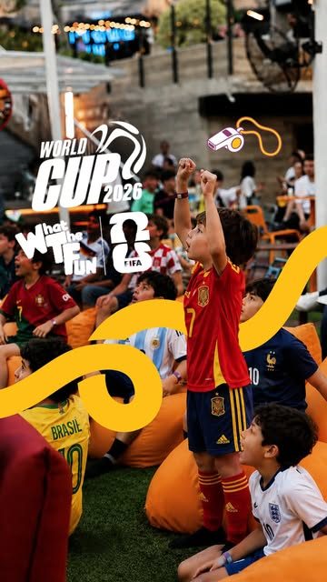 Kids in football jerseys celebrating during a match screening